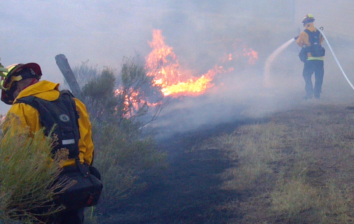 Firefighter wets down area in front of private home in effort to retard the advance of the High Park Wildfire on Thursday June 10 2012 The High Park Wildfire located approximately 15 miles west of Fort Collins CO has consumed over 65 738 acres of forest and grassland with approximately 189 homes destroyed Over 1 773 personnel from the U S Forest Service FS state and local resources are fighting the wildfire and have achieved 55 containment as of June 20 2012 The High Park Wildfire began on June 9 2012 because of a lightning strike on private land
