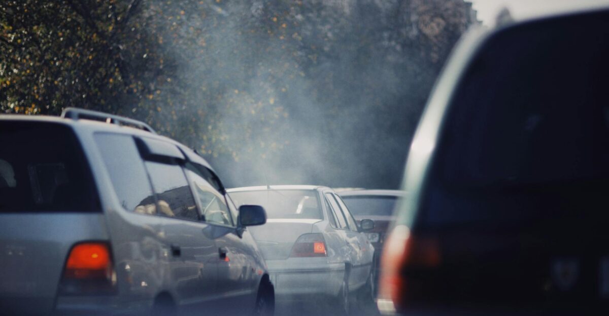 City traffic jam with cars emitting smoke on a busy road