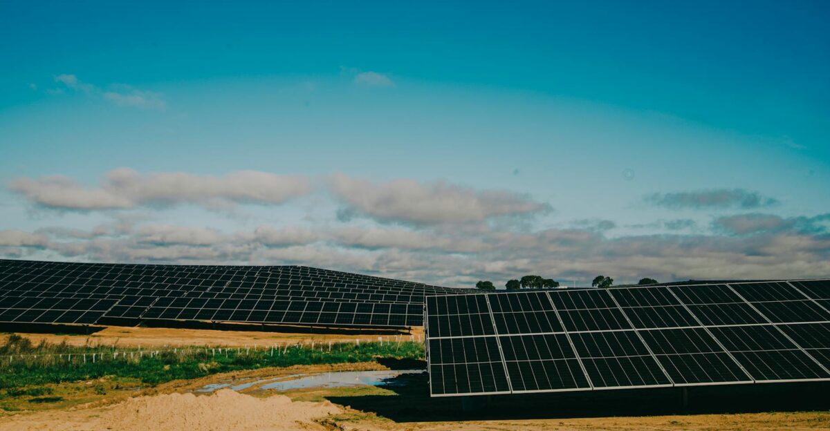 A vast solar farm in a desert setting under clear blue skies showcasing renewable energy