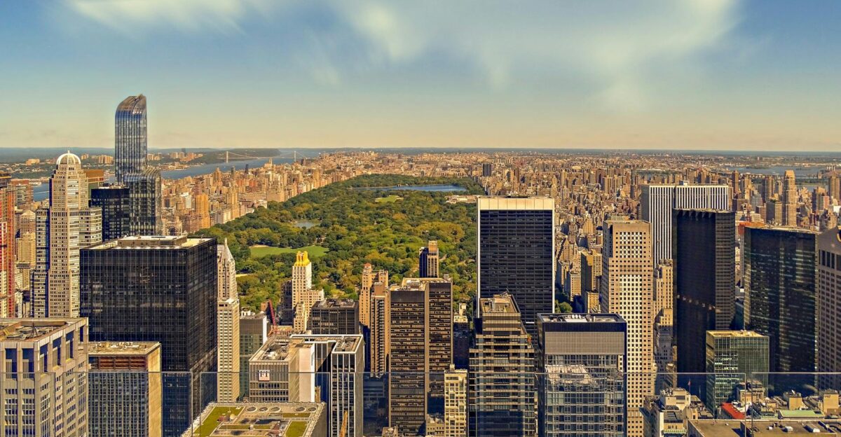 Aerial view of New York City skyline featuring Central Park amidst towering skyscrapers