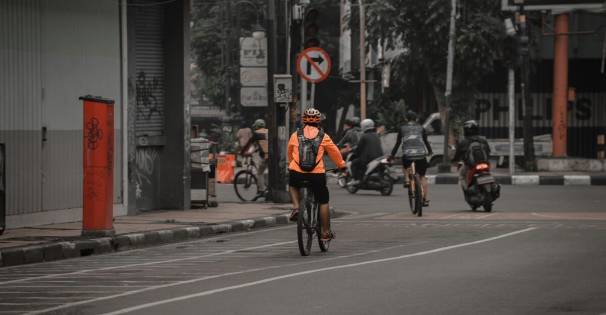 a person riding a bicycle down the street