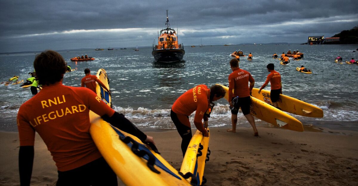 RNLI lifeguards at Tenby in South Wales - lifeguards and lifeboat crew come together to provide safety cover for the annaul Ironman triathlon event Nigel Millard RNLI by RNLI