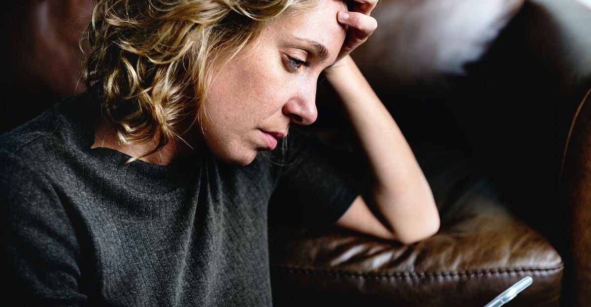 Depressed woman using a mobile phone premium image by rawpixel com by Myriam D sourdy