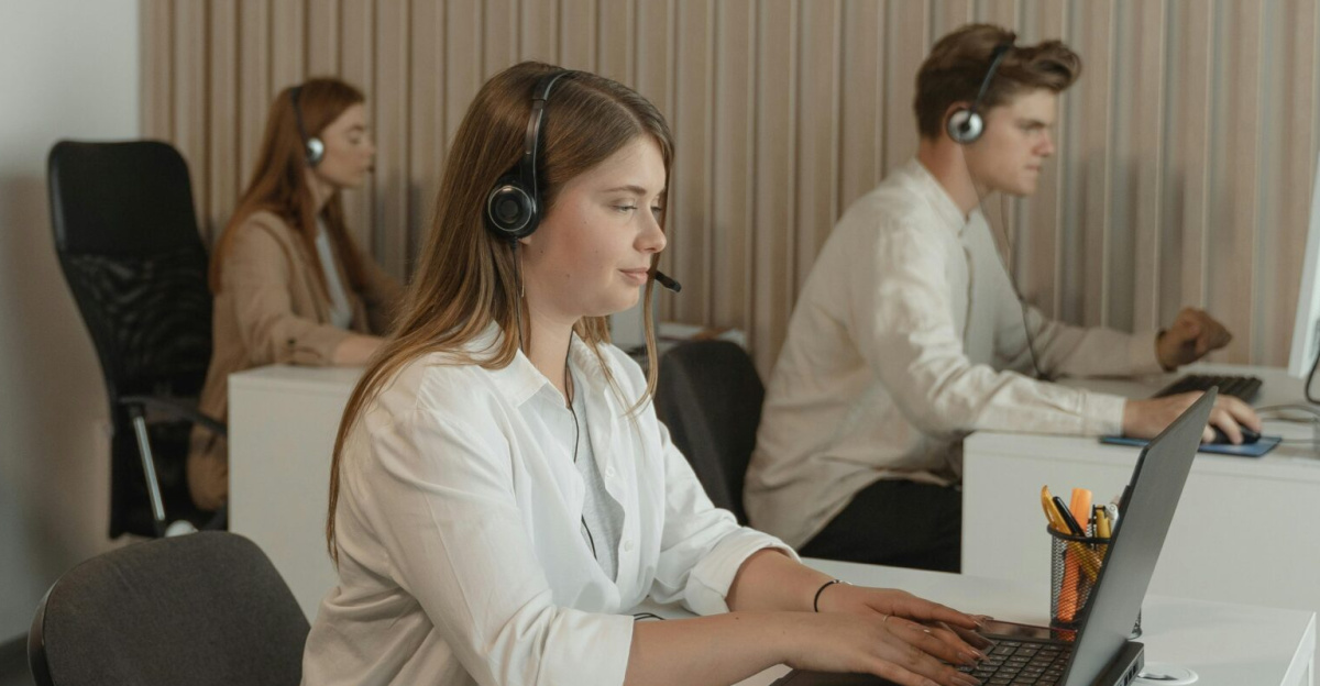 Office scene with call center employees at work, focusing on teamwork and productivity.