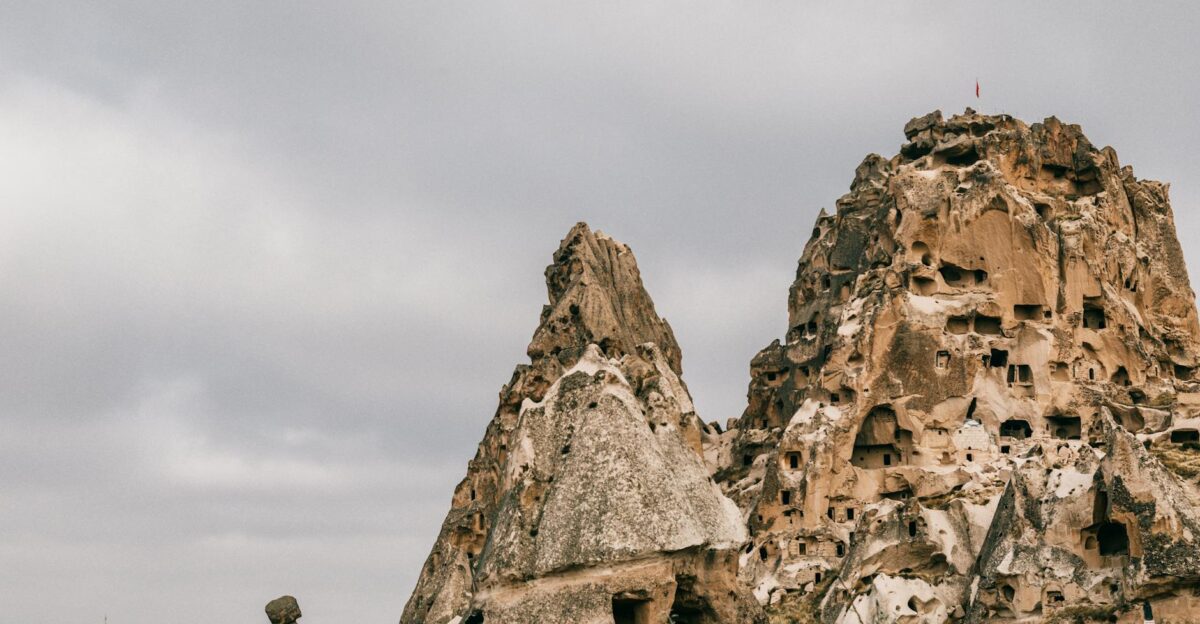Amazing view of ancient houses carved out of volcanic formations in Cappadocia in overcast weather