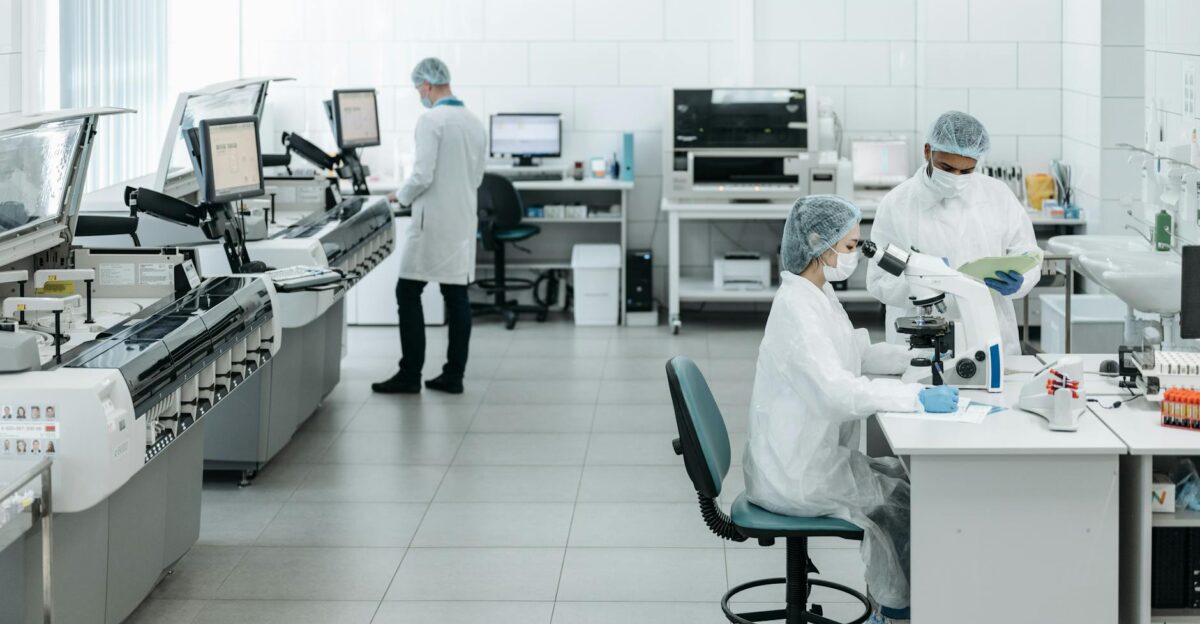 Researchers in lab coats performing experiments with advanced equipment in a laboratory