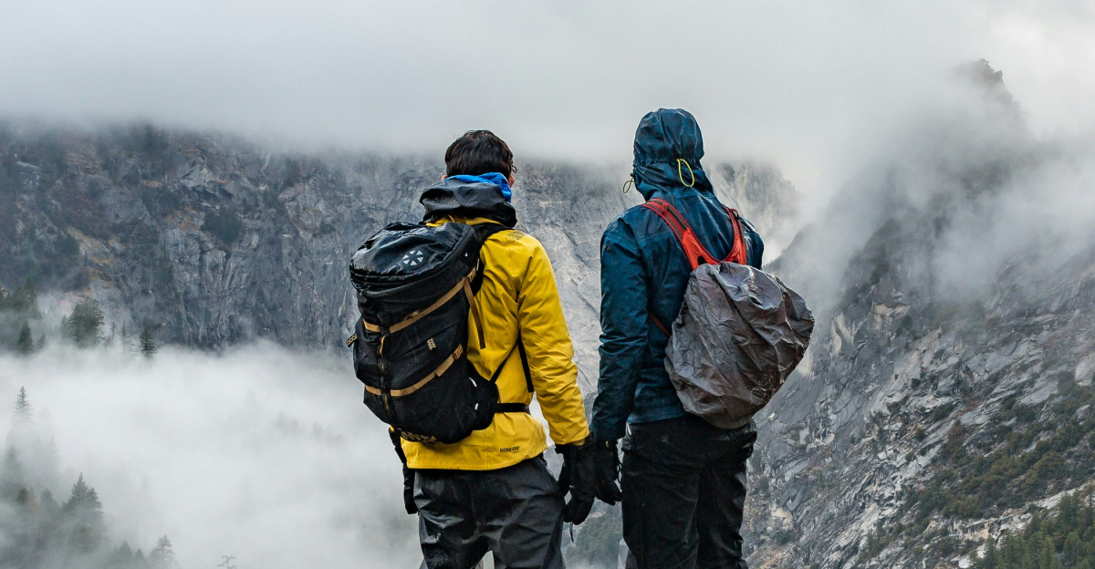 two men standing near cliff during daytime
