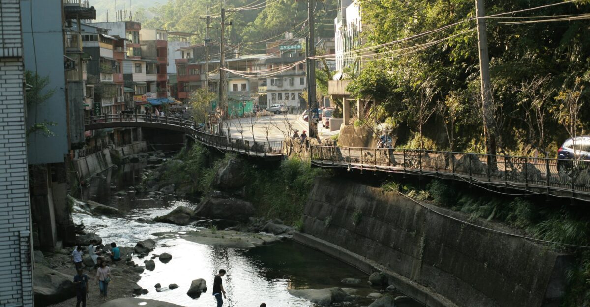 people walking on bridge over river during daytime