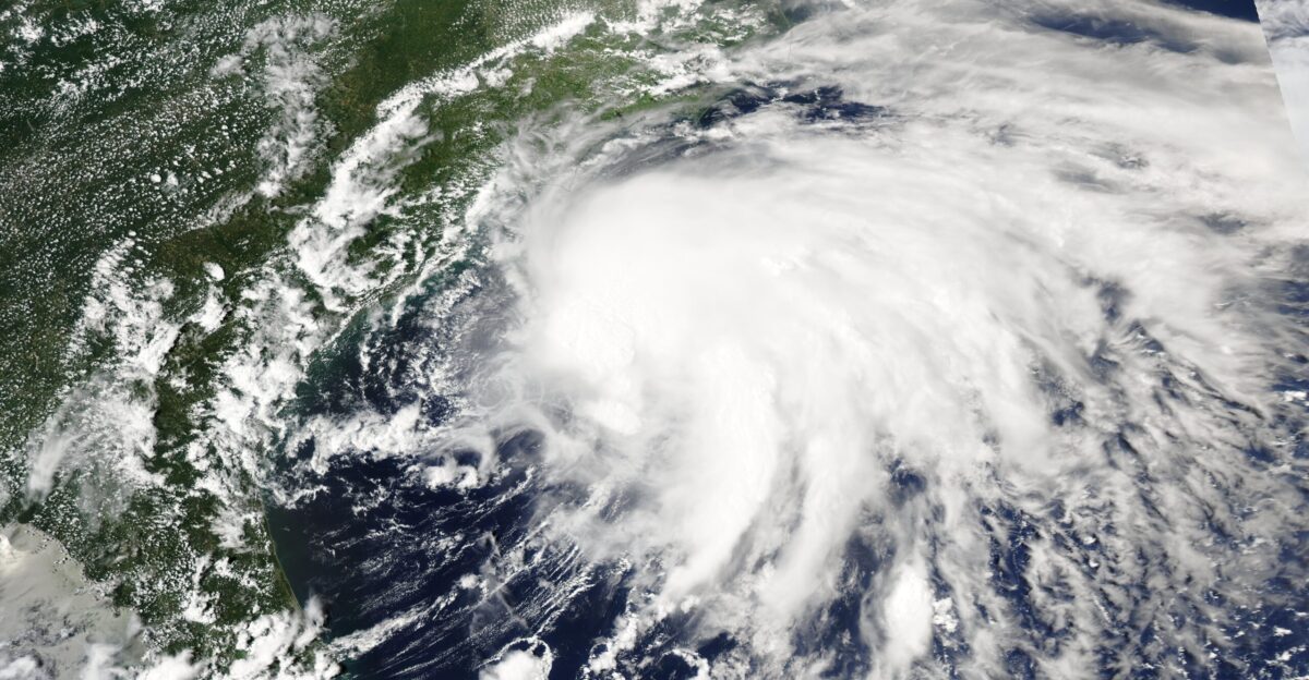 On July 5 2025 the Moderate Resolution Imaging Spectroradiometer MODIS on NASA s Aqua satellite acquired this true-color image of Tropical Cyclone Chantal barreling towards landfall on the South Carolina coast The asymmetric appearance gives evidence that the storm was battling substantial windshear as it approached the mainland According to the National Weather Service NWS southerly windshear kept the system tilted and disorganized during daylight hours on June 5 However the shear relaxed late in the day allowing Chantal to strengthen before landfall On July 6 at 4 00 a m EDT Tropical Storm Chantal moved across the coast near Litchfield Beach South Carolina carrying maximum sustained winds near 60 miles per hour 96 5 km h Tropical Storm Chantal proved to be a heavy rainmaker in the Carolinas dropping as much as 4-6 inches 10-15 cm along a wide swath across both South and North Carolina The NWS advised that a tornado touched down near the Wilmington International Airport in North Carolina at 4 27 a m EDT on July 6 causing damage to trees and roofs Flash flooding in North Carolina has been reported by local media with the NWS in Raleigh advising that the Haw River was cresting at 32 5 feet which is just below record levels brought by Hurricane Fran in 1996 Chantal weakened and was downgraded to a post-tropical storm on July 6 as it moved northward away from the Carolinas but it still remained a strong rainmaker At 11 00 am EDT on July 7 the National Hurricane Center advised that the center of the system was located about 30 miles 50 km north-northeast of Newport News Virginia and about 120 miles 190 km south-southwest of Dover Delaware It was carrying maximum sustained winds of 30 miles per hour 45 km h and was moving towards the northeast Flood watches were in effect for portions of Southern and Eastern Maryland the state of Delaware portions of Southern New Jersey and portions of Southeastern Pennsylvania In addition life-threatening rip currents are expected along the East Coast of the United States from the northeastern coast of Florida to the Mid-Atlantic States for the next several days Chantal is forecast to dissipate by late on July 8 although remnants may continue to bring rain to the Mid Atlantic and Northeast regions beyond that date